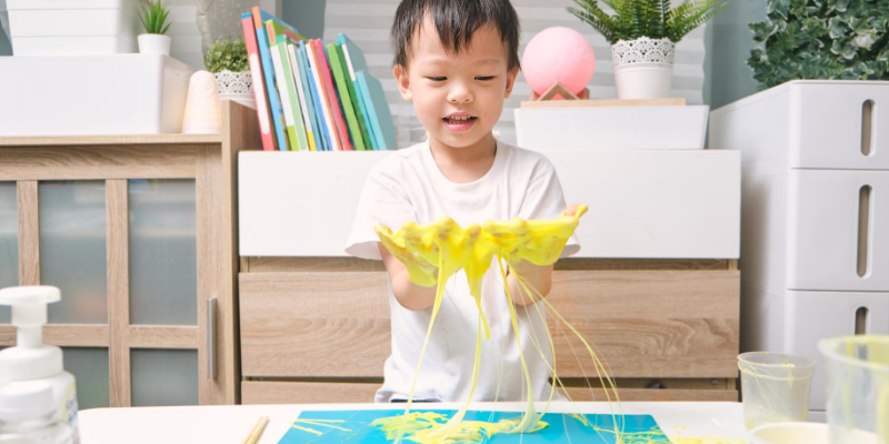 yellow slime, child playing, homemade slime, homemade goop, pet toxins, pet toxicity, toxic crafts, homemade slime toxicity in pets, homemade slime toxicity, homemade crafts, art supplies