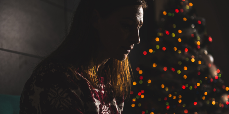 woman, grieving, dark, pet loss, pet grief, holiday grief, holidays, pet parents, Animal Emergency & Referral Center of Minnesota, Human Animal Bond