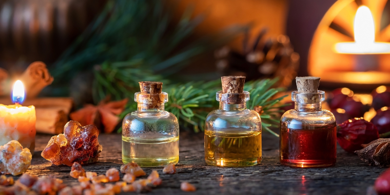 essential oils in corked bottles surrounded by evergreen and spices, holiday pet toxins, Animal Emergency & Referral Center of Minnesota