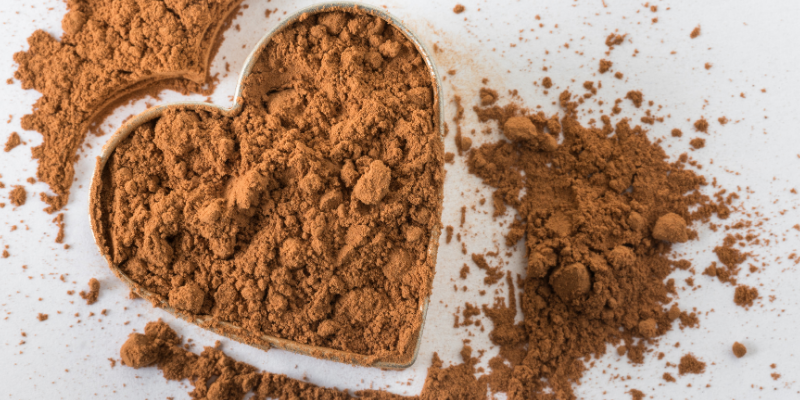 Cocoa powder shaped like a heart on a white background. Animal Emergency & Referral Center of Minnesota.