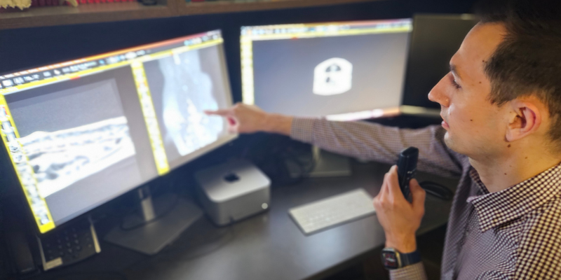 Dr. Nevins, a board-certified veterinary radiologist, in front of multiple monitors reviewing imaging results at Animal Emergency & Referral Center of Minnesota.