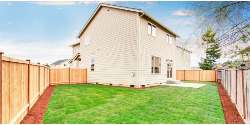 A home with a large, fenced-in backyard.
