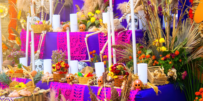 A decorated ofrenda with candles and flowers.