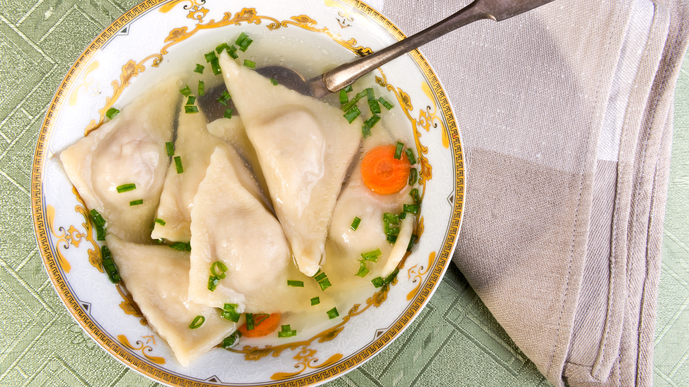 Kreplach served in a dish on a table.