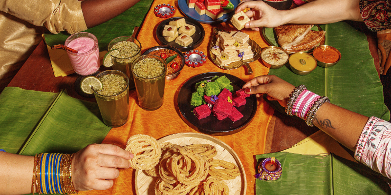 A table spread of traditional Diwali foods.