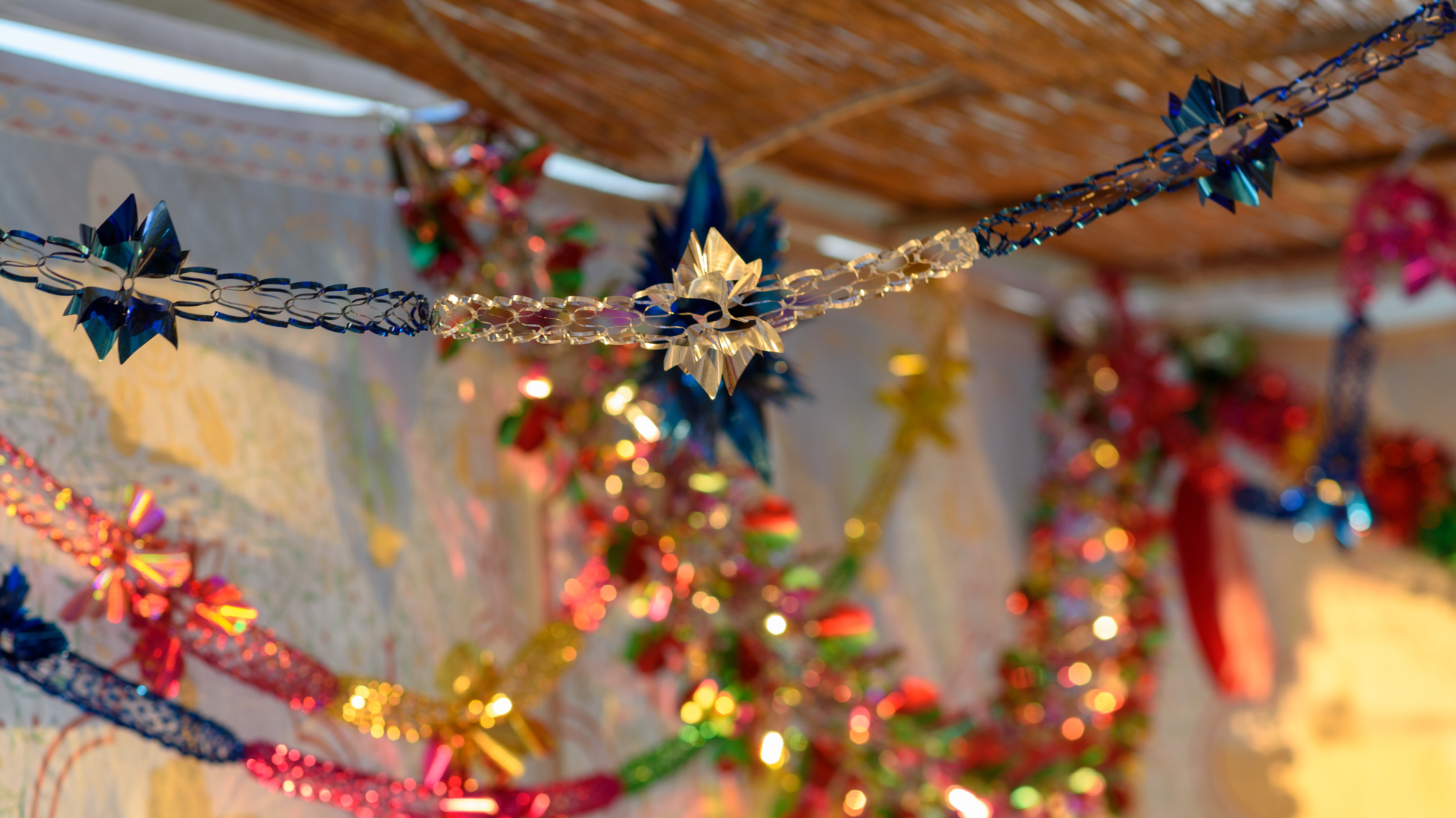 A sukkah decorated with tinsel on the inside.