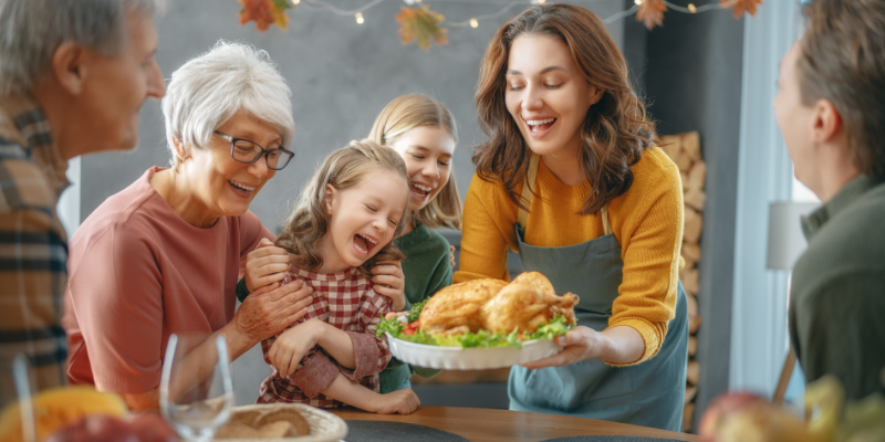 A family gathering around the table for a traditional Thanksgiving feast.