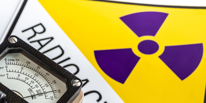 A yellow radiation symbol that says "Radioactive" underneath and a monitoring device.